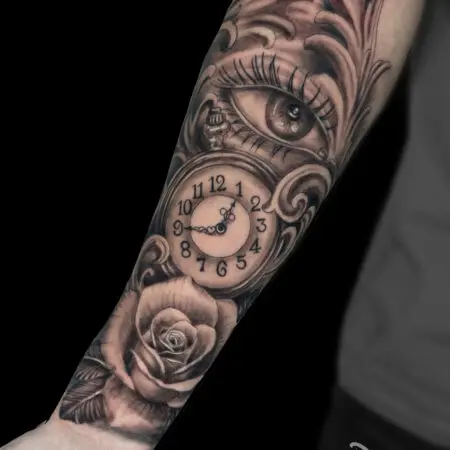 Eye, clock, and rose forearm tattoo in black and grey realism, done at Blesink Tattoo Porto