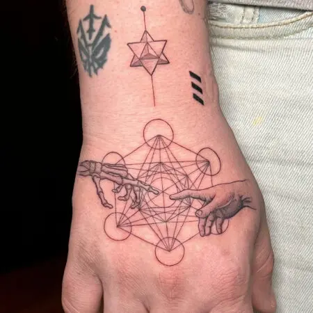 Geometric fine line tattoo on the hand, done at Blesink Tattoo Porto